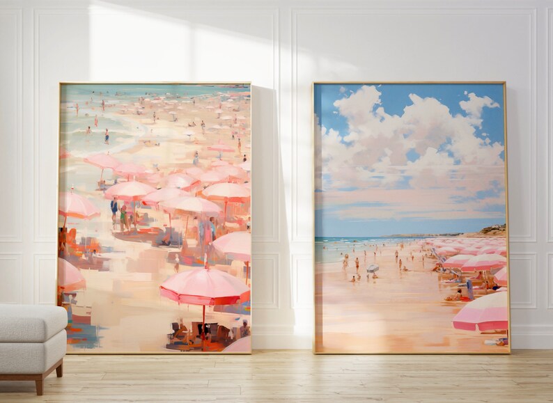 May include: Two framed paintings of a beach scene with pink umbrellas. The painting on the left shows a crowded beach with people under the umbrellas. The painting on the right shows a less crowded beach with a blue sky and white clouds.
