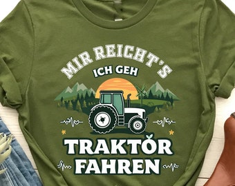 May include: Green t-shirt with a white graphic of a tractor and the text "Mir reicht's Ich geh Traktor Fahren".