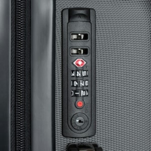 May include: Close-up of a black combination lock with a red diamond logo and three dials. The dials are set to 21, 74, and 15.