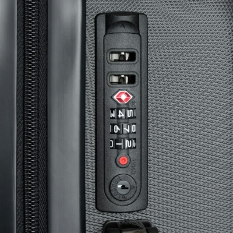 May include: Close-up of a black combination lock with a red diamond logo and three dials. The dials are set to 21, 74, and 15.