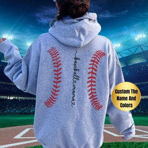 May include: Gray hooded sweatshirt with a baseball graphic and the text "baseball mama" on the back. The sweatshirt is customizable with different names and colors.