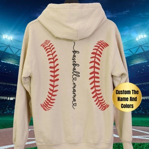 May include: A beige hoodie with a baseball graphic and the text "baseball mama" on the back. The baseball graphic is red and white.