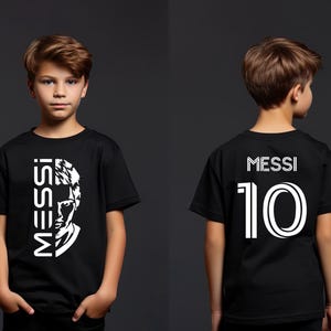 a young boy wearing a black messi shirt