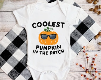 May include: White baby onesie with a pumpkin wearing sunglasses and the text "Coolest Pumpkin in the Patch".