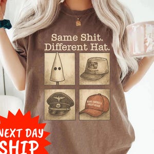 May include: Brown t-shirt with the text "Same Shit. Different Hat." and four hat illustrations. The illustrations include a KKK hood, a military hat, a Nazi hat, and a "Make America Great Again" hat.