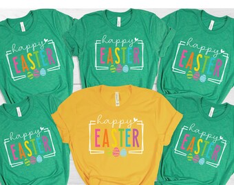 May include: Five t-shirts with the text "happy easter" in a colorful font with a heart and Easter eggs.  The shirts are green and yellow.