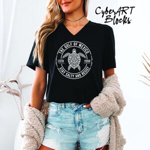 a woman wearing a black shirt with a turtle on it