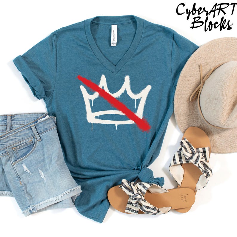 a casual outfit consisting of a blue t-shirt with a white crown graphic, denim shorts, and a beige hat.