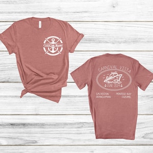 a couple of t - shirts sitting on top of a wooden floor