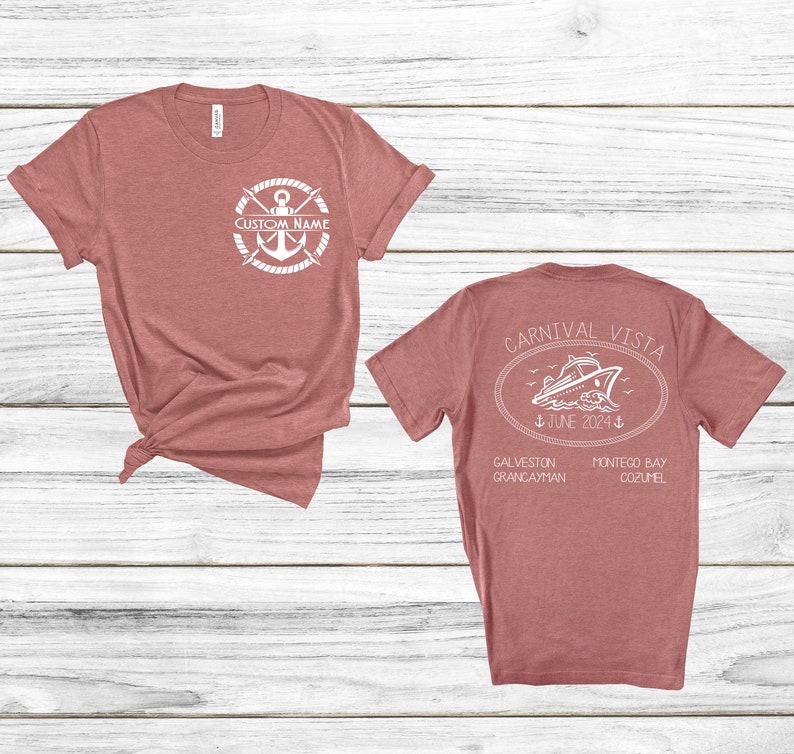 a couple of t - shirts sitting on top of a wooden floor