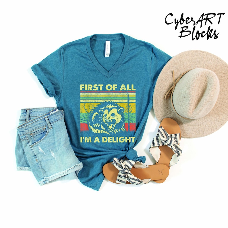 a blue shirt with a lion on it next to a hat