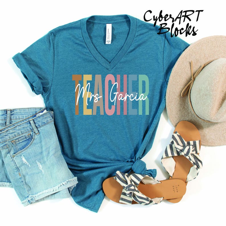 a t - shirt that says teacher next to a pair of jeans and a hat