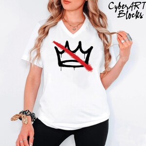 A woman wearing a white t-shirt with a graphic design of a crown and a red diagonal line across it.