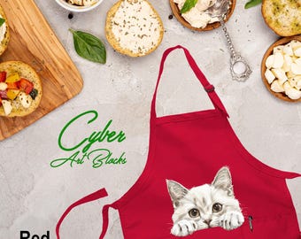 May include: Red kitchen apron with a white cat peeking out of the pocket. The cat has green eyes and white fur. The apron has a large pocket on the front.