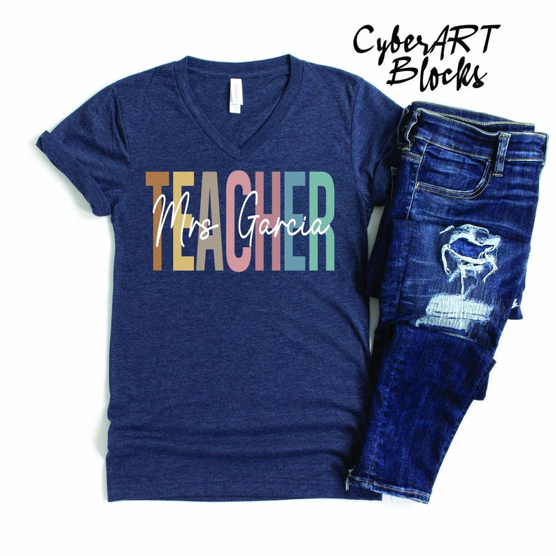 a t - shirt that says teacher next to a pair of jeans
