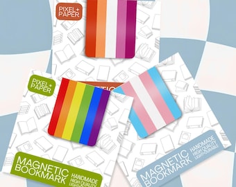 May include: Three magnetic bookmarks displayed on white cards with a book pattern. One bookmark features orange, white, and magenta stripes; another has a rainbow stripe pattern; and the third shows light blue, pink, and white stripes. Text reads PIXEL+PAPER.