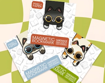 May include: Three magnetic bookmarks featuring cartoon cat illustrations with large eyes. Each bookmark is attached to a square backing card with a white book pattern. The text PIXEL+PAPER, MAGNETIC BOOKMARK, HANDMADE, HIGH QUALITY, LIGHT+DURABLE is visible.