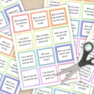 May include: A set of colorful cards with questions for a game. The cards are printed with a variety of questions, such as "What's your least favorite part of the day?" and "What's the nicest thing you've done for someone else?"