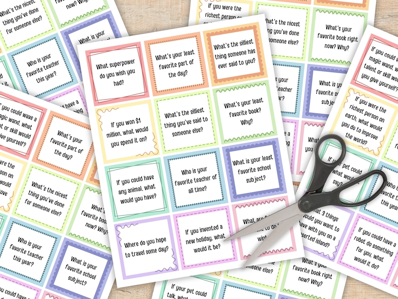 May include: A set of colorful cards with questions for a game. The cards are printed with a variety of questions, such as "What's your least favorite part of the day?" and "What's the nicest thing you've done for someone else?"