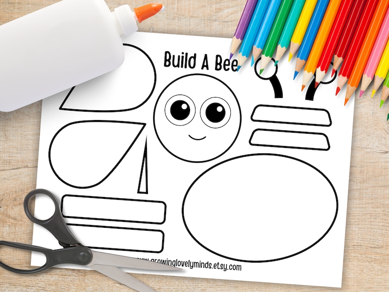 May include: A printable craft activity for kids to build a bee. The printable includes a bee body, wings, eyes, antennae, and a stripe pattern. The text "Build A Bee" is at the top of the page.
