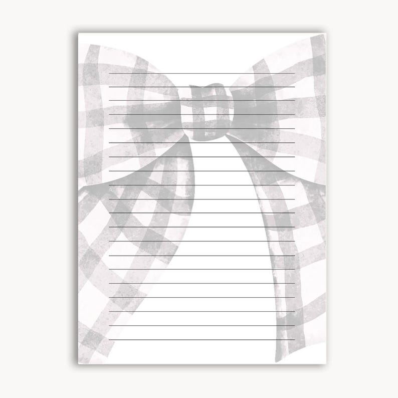 Peut inclure: Un bloc-notes lign&eacute; avec un motif aquarelle d'un n&oelig;ud vichy gris et blanc en haut. Le n&oelig;ud est centr&eacute; et occupe le tiers sup&eacute;rieur de la page. Les lignes sont noires et espac&eacute;es uniform&eacute;ment.