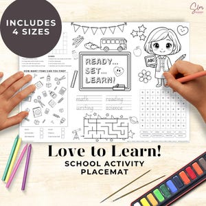 May include: School activity placemat with the text "Love to Learn!" and "School Activity Placemat". The placemat includes a maze, word search, and other activities. The image also includes a watercolor paint set and coloured pencils.
