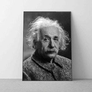 May include: Black and white portrait photograph of Albert Einstein. He is wearing a tweed jacket and has a distinctive hairstyle.