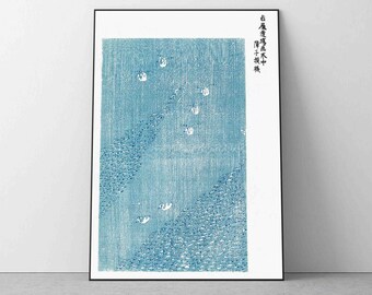 May include: A blue and white Japanese woodblock print depicting a scene of a flock of birds flying over a patterned background. The text in the image reads "白鳥群飛水天中", which translates to "White birds flying in the sky and water".