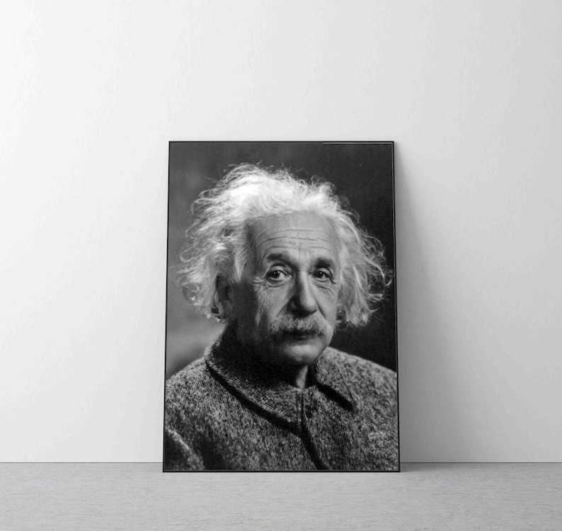 May include: Black and white portrait photograph of Albert Einstein. He is wearing a tweed jacket and has a distinctive hairstyle.