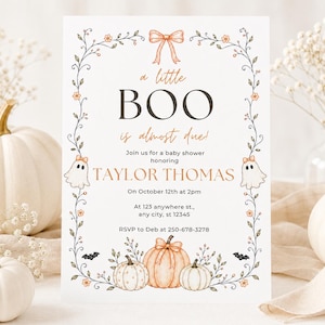 May include: A rectangular baby shower invitation card featuring a white background with a floral vine border, a peach bow, two ghosts, and pumpkins. The text reads: a little BOO is almost due! Join us for a baby shower honouring TAYLOR THOMAS.