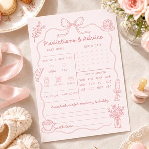 Pink predictions and advice baby shower game card shown in a soft brunch flat lay with latte, croissant, blush flowers, baby booties, and pink ribbon.