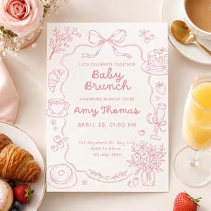 May include: A white rectangular baby brunch invitation card with pink line art illustrations of a bow, croissant, coffee cup, pancakes, champagne flute, and flowers. The text reads: Let's Celebrate Together Baby Brunch Honoring Mommy-to-be Amy Thomas.