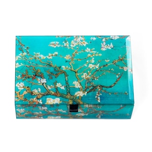 May include: A turquoise blue wooden box with a hinged lid. The lid features a printed image of a white flowering almond tree against a turquoise blue background. The box has a black metal latch.