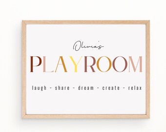 May include: A framed print with the text "Olivia's Playroom" in colorful letters. The text "laugh - share - dream - create - relax" is printed below the title.