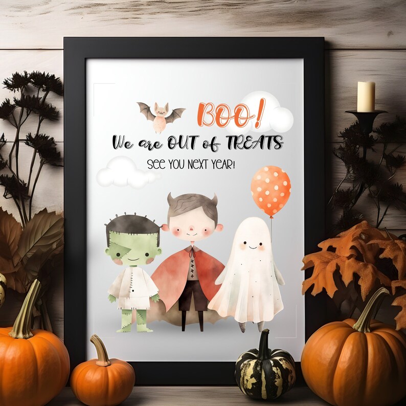 May include: A printable Halloween sign with a black frame. The sign says "BOO! We are out of treats. See you next year!" and features a cartoon bat, a ghost, a vampire, and a green monster.