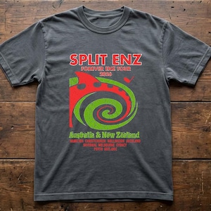 May include: Charcoal grey t-shirt with the words "SPLIT ENZ FOREVER ENZ TOUR 2026" in red. The shirt features a red and green spiral graphic. Tour locations in Australia and New Zealand are listed below the graphic.