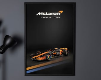 May include: A black framed poster with a black background featuring a McLaren Formula 1 Team race car in orange and black with the McLaren logo in white. The car is on a black and blue striped background.