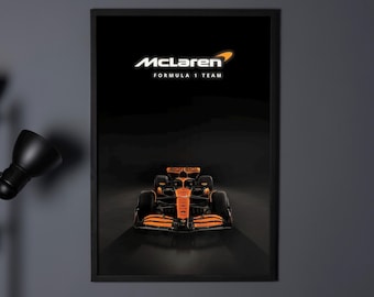 May include: A black framed poster with a white McLaren Formula 1 Team logo and a black and orange race car in the center.