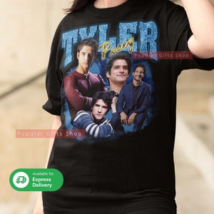 May include: Black t-shirt with a vintage-style graphic featuring Tyler Posey from the TV show Teen Wolf. The graphic includes four images of Tyler Posey in different poses. The text "Tyler Posey" is written in a blue and white font.