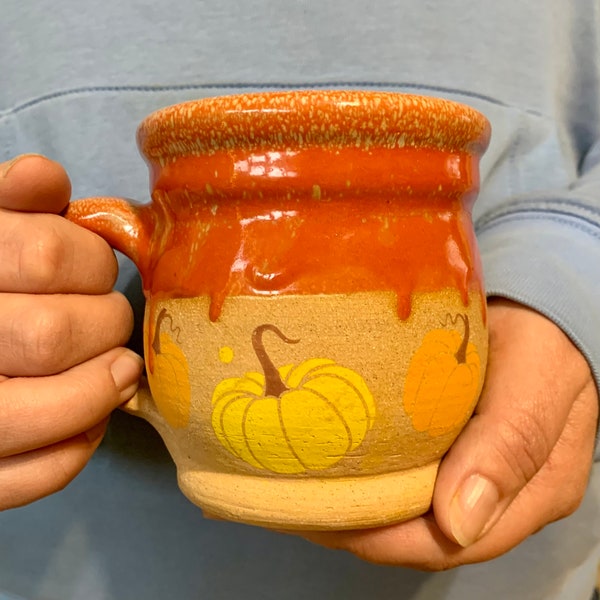 Pumpkin Patch Mug. 12oz stoneware mug with underglaze pumpkins and bright orange speckled glaze