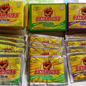 May include: A variety pack of Extra Joss Active Flavored Drink Base in yellow, green, and purple boxes. The boxes feature a raised fist and the text "Extra Joss" in a bold, red font. The drink base is available in flavours like Ginseng, Mangga, and Anggur.