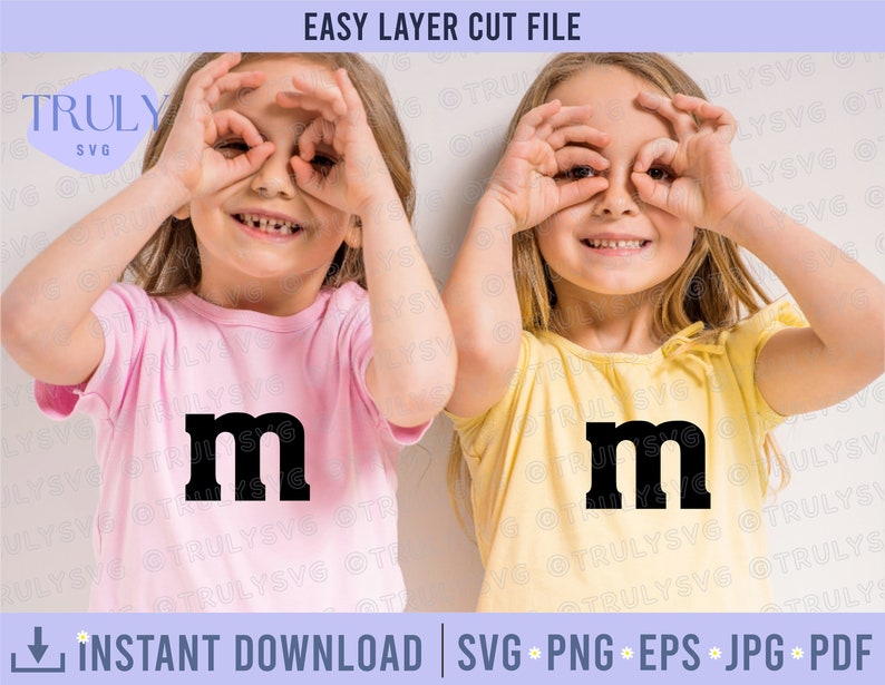 May include: Two children wearing pink and yellow shirts with the letter "m" printed on the front. They are both making a silly face with their hands over their eyes.