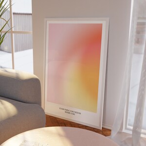 May include: A white framed print with a blurred pink, orange, and yellow gradient background. The print has the text "Everything you need is within you" at the bottom.