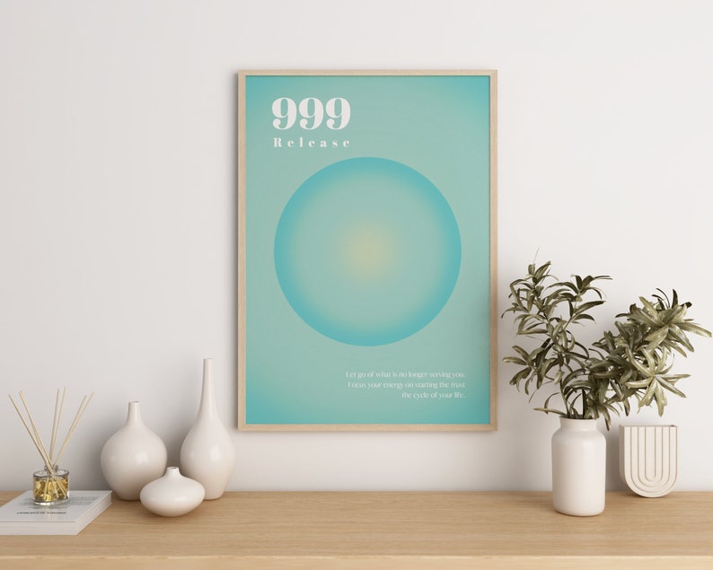 May include: A framed poster with a teal background and a large white circle in the center. The poster has the text "999 Release" and a quote about letting go of what is no longer serving you.