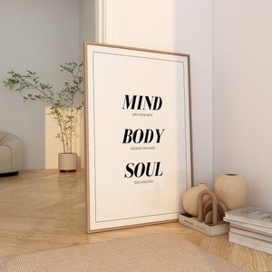May include: A framed print with the words "MIND OPEN YOUR MIND BODY NOURISH YOUR BODY SOUL FEED YOUR SOUL" in black text on a white background.