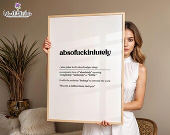 May include: A rectangular wall art print in a light wood frame featuring a dictionary-style definition of the word absofuckinlutely. The text includes phonetic pronunciation, part of speech, a definition, and an example sentence in black ink.