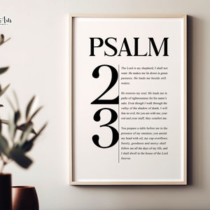 May include: Framed wall art print featuring the text "PSALM 23" in large black font. The artwork includes the full text of Psalm 23 in a smaller font. The frame is a light color, and the background is white.
