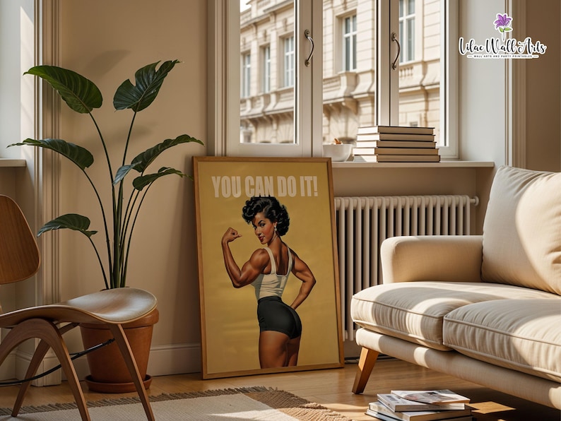 May include: A rectangular wall art print featuring a retro-style illustration of a person flexing their arm muscles. The person wears a white tank top and black shorts. The text YOU CAN DO IT! is printed in white at the top of the tan-colored poster.