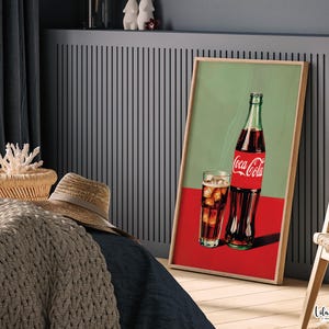 May include: A vintage-style print featuring a glass of cola with ice and a bottle of Coca-Cola. The background is a green and red color scheme.