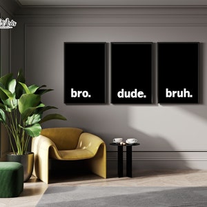 May include: Three black framed prints with white text on a gray wall. The prints read "bro." "dude." and "bruh."